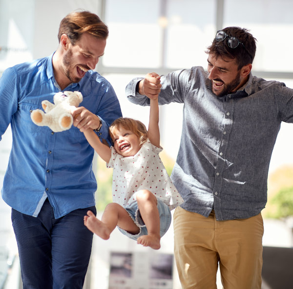 Happy,Child,Girl,At,Shopping,With,Gay,Parents.family,Having,Fun